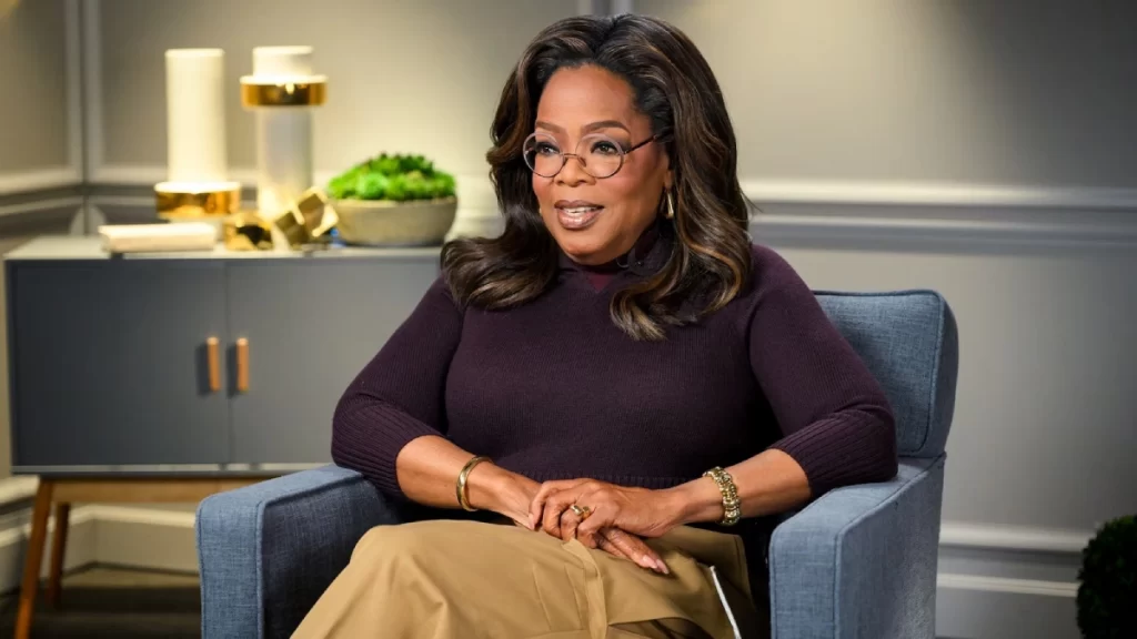 Oprah Winfrey delivering keynote speech at media conference, showcasing the billionaire television host and entrepreneur who built $3.1 billion entertainment empire