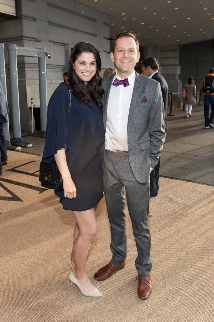 A man and woman standing together at an event, identified as David Friedberg and his wife.