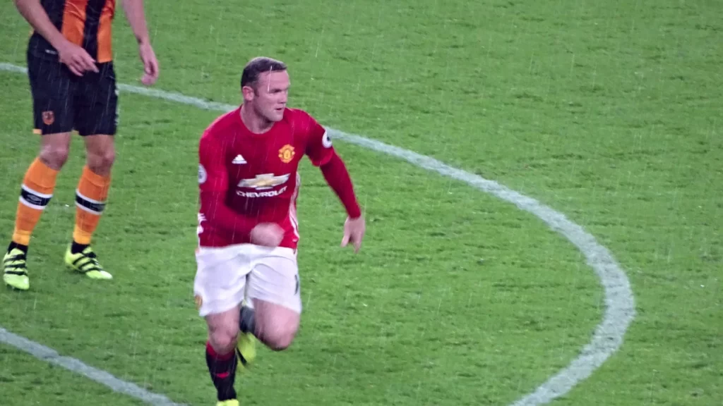 I’m a Celebrity 2026 Rumoured Line-Up Ranked by Net Worth: Who Is the Richest Star Heading to the Jungle? Wayne Rooney running on the pitch in a red Manchester United shirt and white shorts during a rainy Premier League match away at Hull City in 2016.